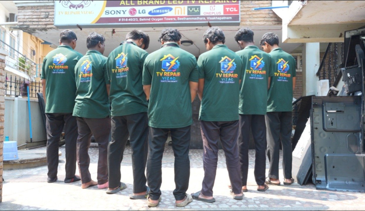 Back view of TV Repair Vizag technicians wearing branded uniform t-shirts